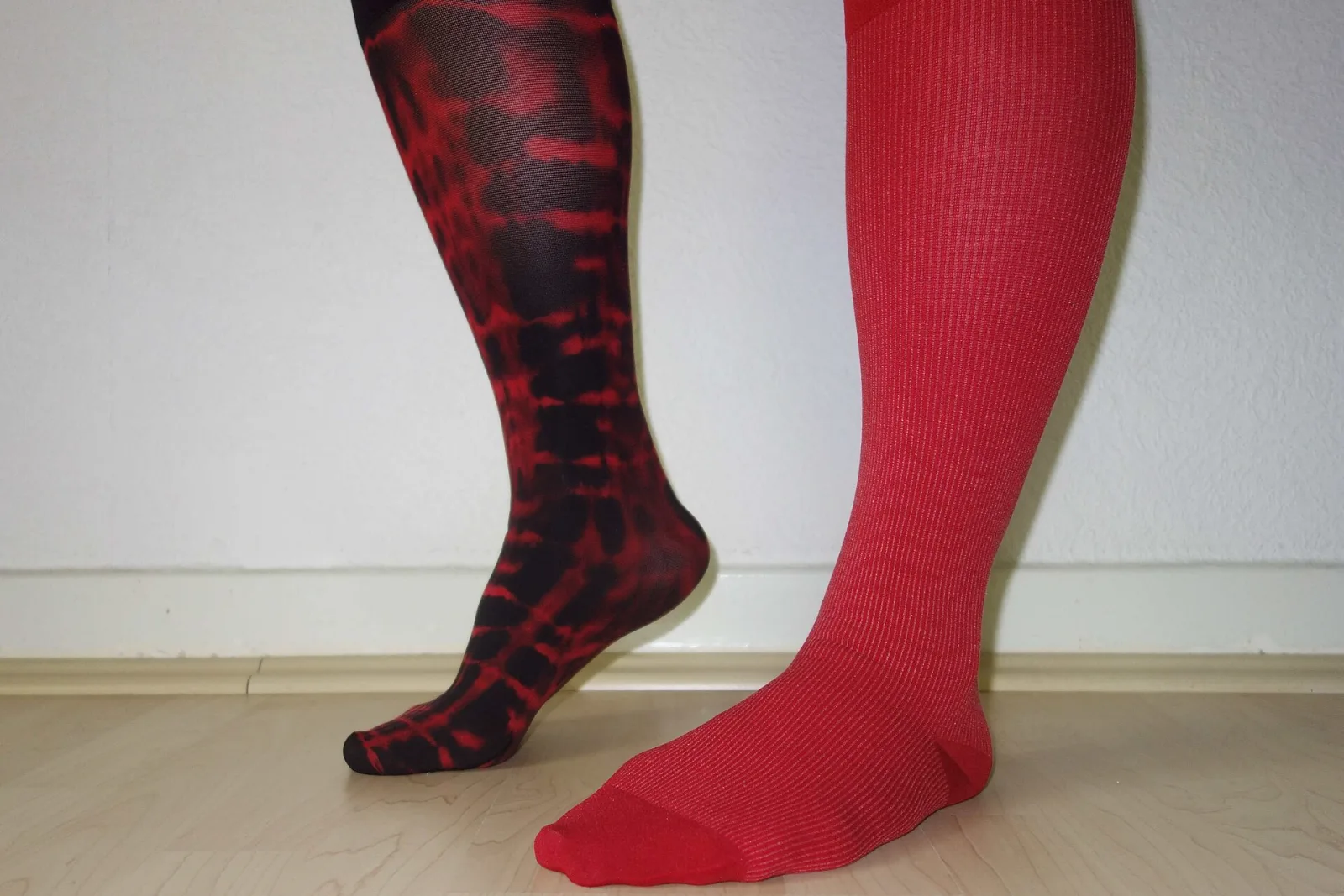 Several pairs of medical compression stockings in different colors and patterns