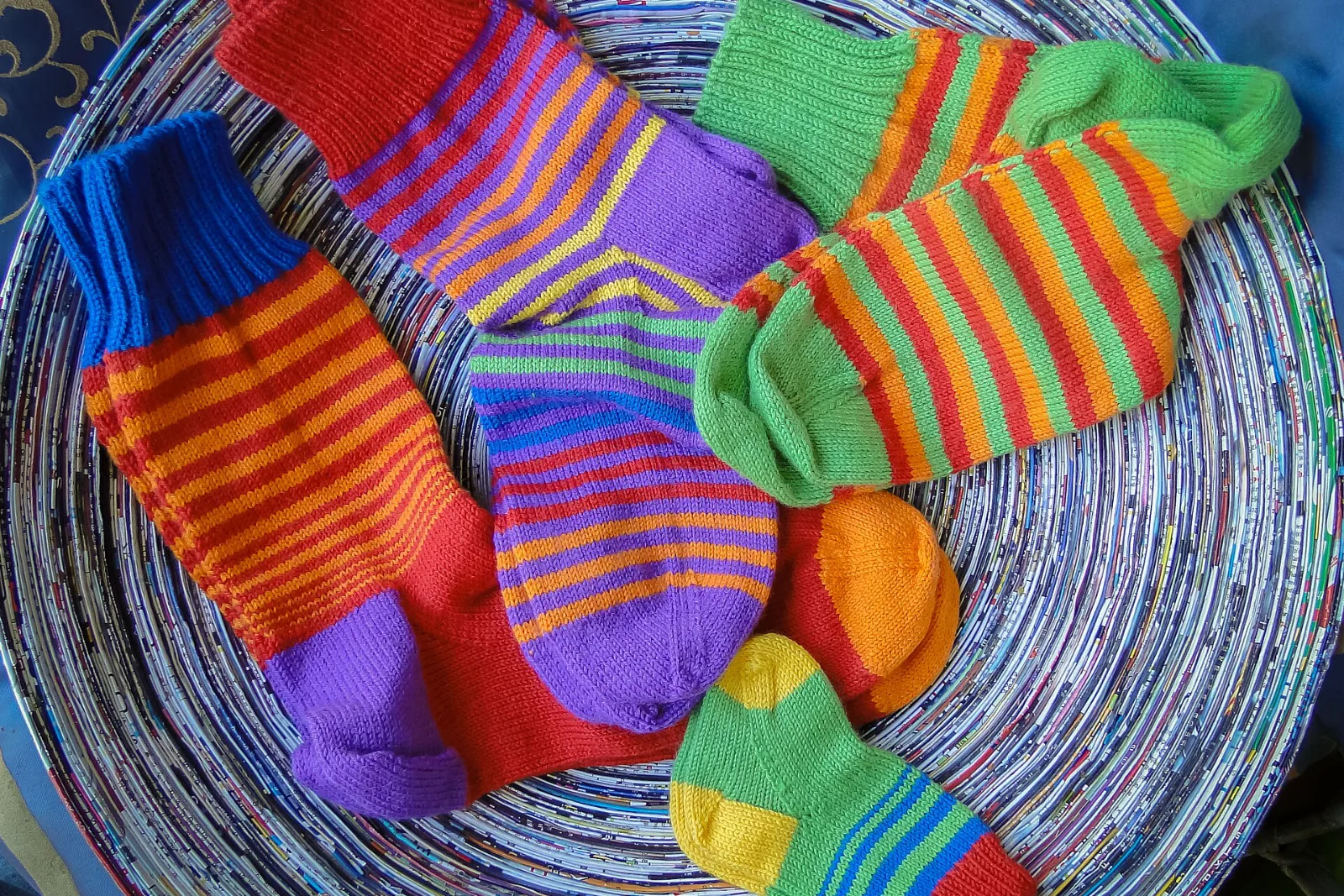 A pile of colorful hand-knitted wool socks