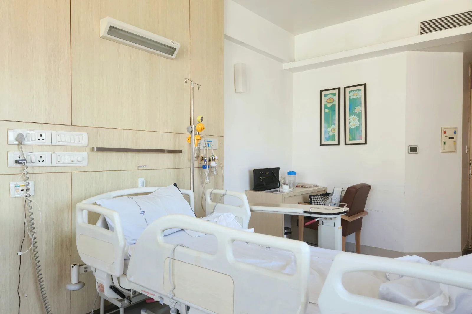 Hospital room with two made beds
